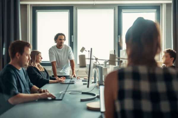 A creative agency team collaborating during a meeting in a modern office